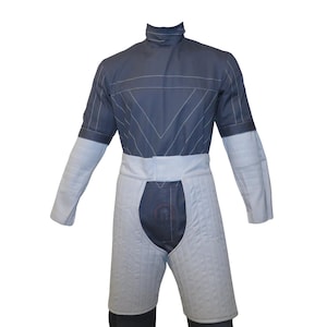 May include: A grey and white padded fencing suit. The upper body is grey with white stitching and a high collar. The lower portion is white, quilted, and covers the thighs. The suit has a white belt and long sleeves.
