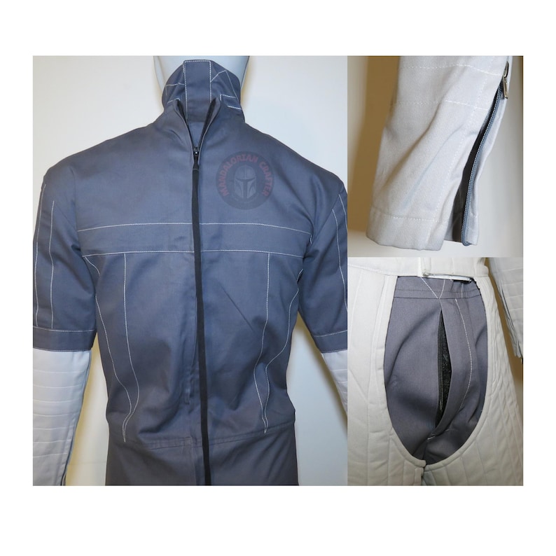 以下が含まれることがあります： 白のアクセントと黒いジッパーが付いたグレーのジャンプスーツ。コスチュームはハイカラーと白い袖口の半袖が特徴です。胸にはマンダロリアンクレストが見えます。