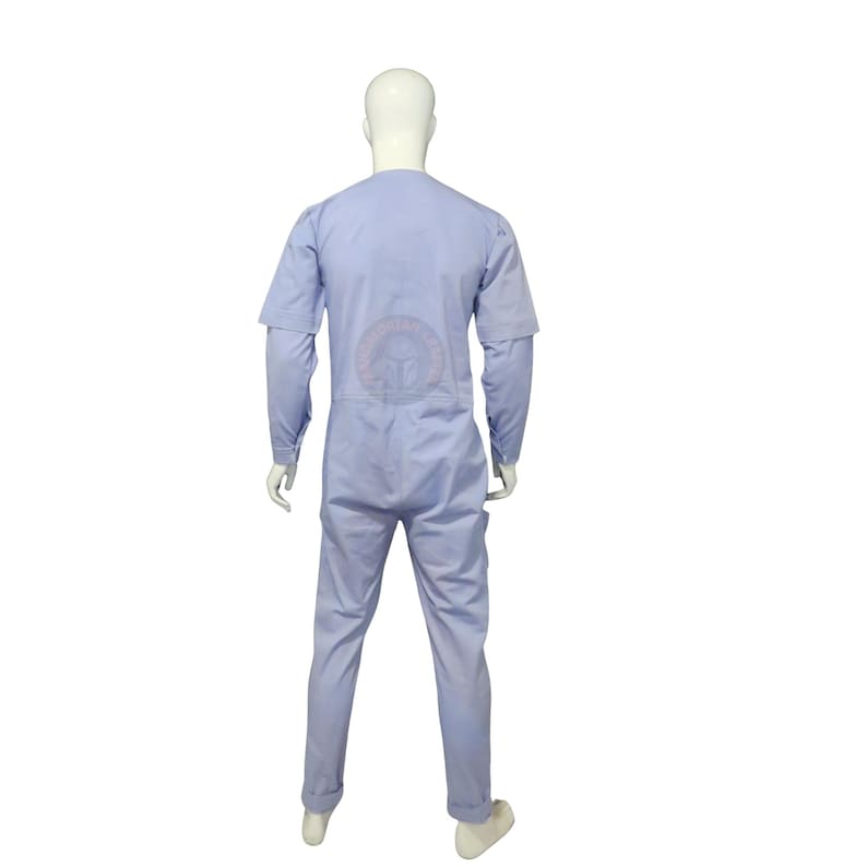 May include: A light blue jumpsuit on a mannequin. The garment features long sleeves with a short sleeve overlay, a round neckline, and straight-leg trousers. The mannequin is set against a white backdrop.