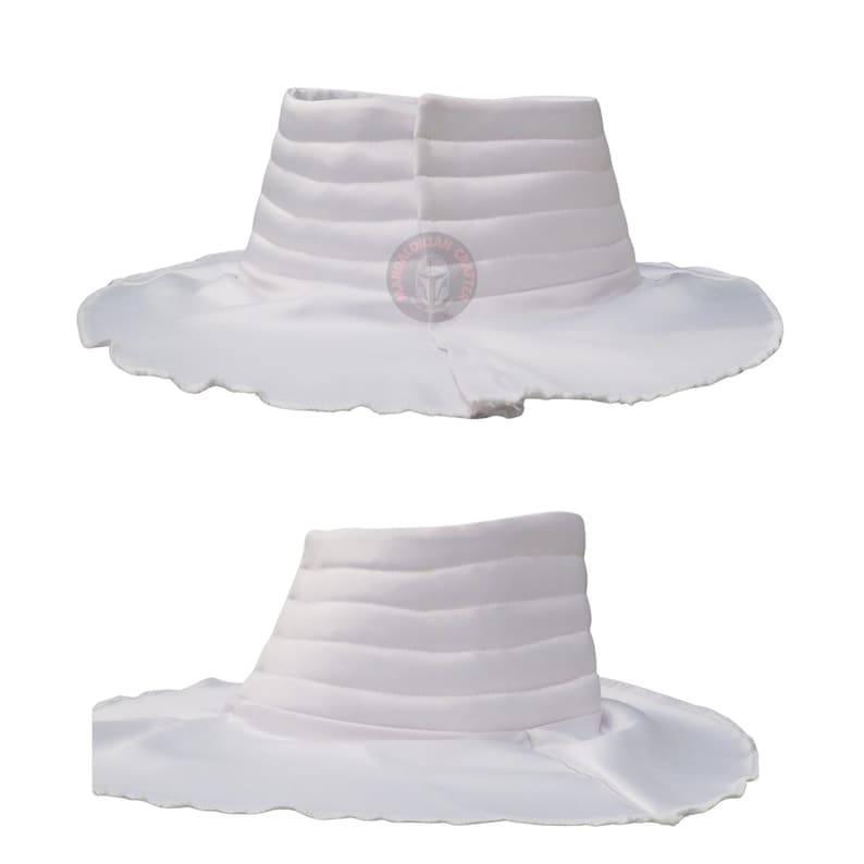 May include: Two white hats are shown. Each hat has a structured, cylindrical crown with horizontal, ribbed detailing. The wide brims have a scalloped edge. The hats appear to be made of a soft, flowing fabric. The hats are displayed against a white background.