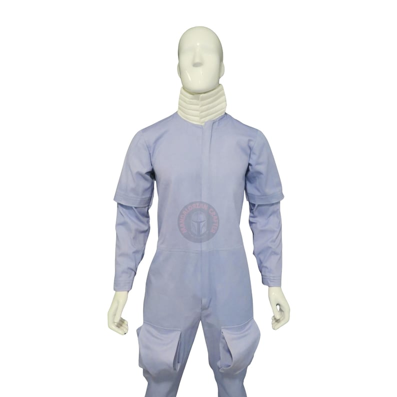 May include: A pale blue jumpsuit with long sleeves and two large pockets on the legs. The jumpsuit has a white collar and is displayed on a mannequin. The sleeves are short at the shoulder and long underneath.