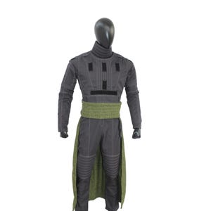 May include: A dark gray costume with a high collar, long sleeves, and a green textured sash. The costume has white stitching details and a green panel on the lower front. The mannequin is on a white background.