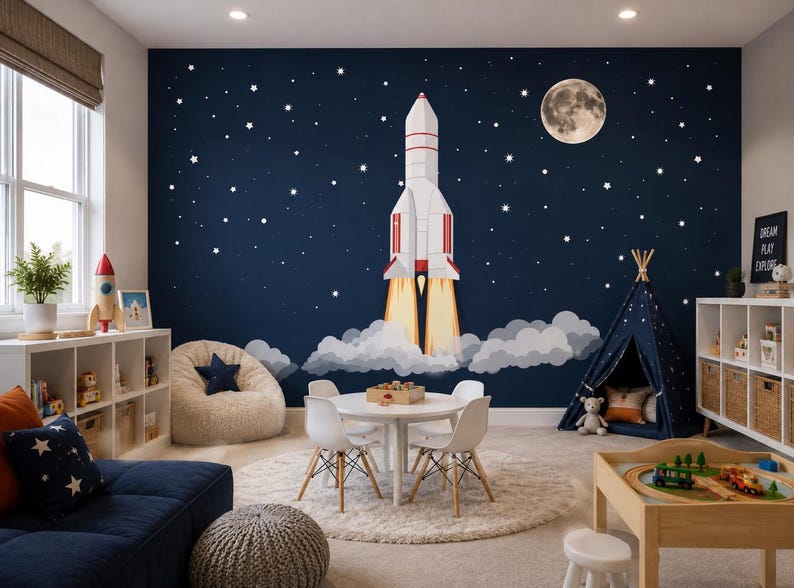 May include: A child's playroom with a navy blue wall mural featuring a rocket ship blasting off into space, a full moon, and stars. The room includes a white table and chairs, a beanbag chair, and a teepee.