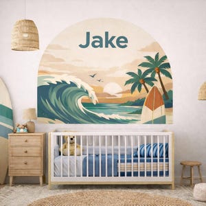 May include: A nursery with a coastal theme. A cot, surfboard, and wall art featuring a beach scene with the name "Jake" are visible. The room is decorated in neutral tones with natural wood accents.