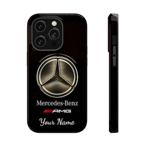 May include: Black phone case featuring the Mercedes-Benz logo in gold and a black background. The case includes the text "Mercedes-Benz", "AMG", and "Your Name". The case has a glossy finish and a side view.