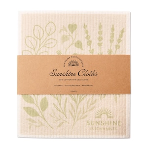 May include: A pack of beige Sunshine Cloths with a brown band. The cloths have a light green botanical print. The band reads "Sunshine Cloths" and lists the material composition as 70% cellulose and 30% cotton.