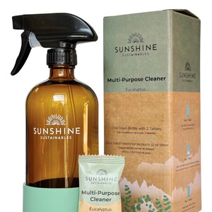 May include: An amber glass spray bottle with a black trigger, a green base, and a box of multi-purpose cleaner tablets. The box and packet feature the text "SUNSHINE SUSTAINABLES" and "Eucalyptus". The bottle is designed for cleaning.