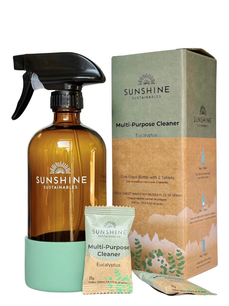 May include: An amber glass spray bottle with a black trigger, a green base, and a box of multi-purpose cleaner tablets. The box and packet feature the text "SUNSHINE SUSTAINABLES" and "Eucalyptus". The bottle is designed for cleaning.