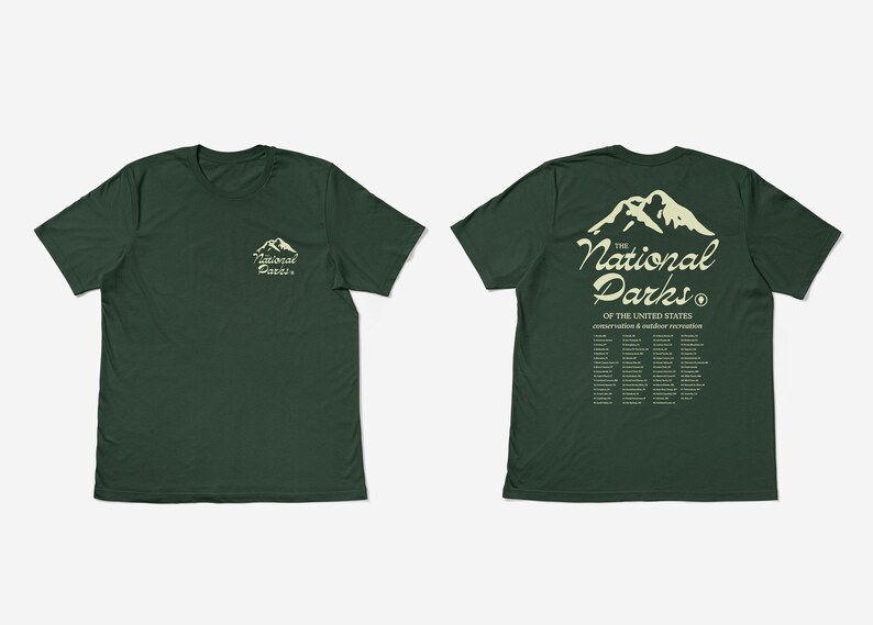 May include: Two dark green t-shirts. One shows a mountain graphic and the text "The National Parks" on the front and back. The back of the shirt also lists the names of the National Parks. The other shirt has the same mountain graphic and text on the front.