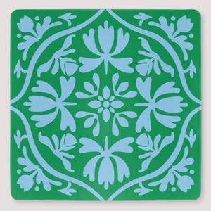 May include: A square coaster featuring a vibrant green background with a symmetrical light blue floral pattern. The design consists of a central flower surrounded by four stylized blossoms and curved lines that form a decorative border.