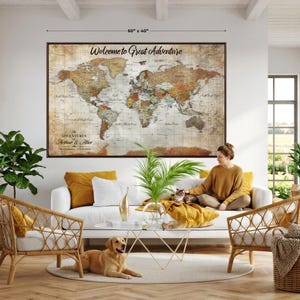 May include: A large rectangular world map wall art piece measuring 60 inches by 40 inches. The map features a vintage-style aesthetic with muted brown, tan, and cream tones, displaying the text Welcome to Great Adventure and The Adventures of Arthur & Alice.