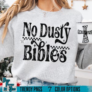 May include: A light gray sweatshirt with the words "No Dusty Bibles" in a black, retro font. The sweatshirt also features a white mug with the words "Hope, Faith, Love, Joy, Peace" in a cross design.