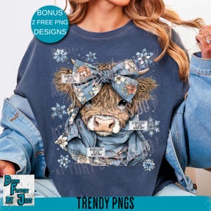 May include: A navy blue sweatshirt features a cow graphic with a floral bow and scarf. The cow has brown fur and a light pink nose. The design includes the text "DESIGN FACTORY BY JESS DO NOT COPY" and "TRENDY PNGS".