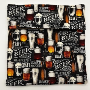 May include: A black fabric sandwich bag with a repeating pattern of beer glasses, mugs, and bottles. The words "BEER", "CRAFT", and "BREW HOUSE" are written in white script across the bag.