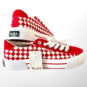 May include: A pair of red and white checkered platform sneakers with white laces and a thick white rubber sole. The Mudd brand logo is visible on the heel, the side, and the attached paper tag. The shoes feature a red suede-like heel panel.