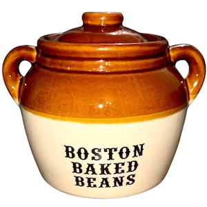 May include: A ceramic Boston Baked Beans pot with a lid and two handles. The pot is brown and cream-colored with the words "BOSTON BAKED BEANS" in black lettering. A classic kitchenware item.