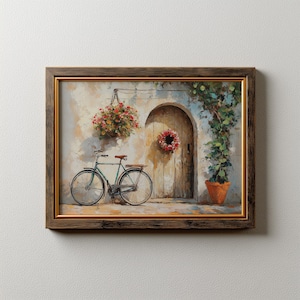 Puede incluir: Obra de arte enmarcada que representa una bicicleta vintage estacionada cerca de una puerta arqueada rústica. Una cesta colgante de flores y una corona adornan la pared. La pintura presenta una bicicleta verde, una puerta de madera y una maceta de terracota con vegetación.