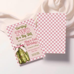 May include: Pink and white gingham birthday invitation with the text "Turning TWO is a Big Dill." The invitation features a pickle jar illustration and a pink bow. The second card has a pink and white gingham pattern.