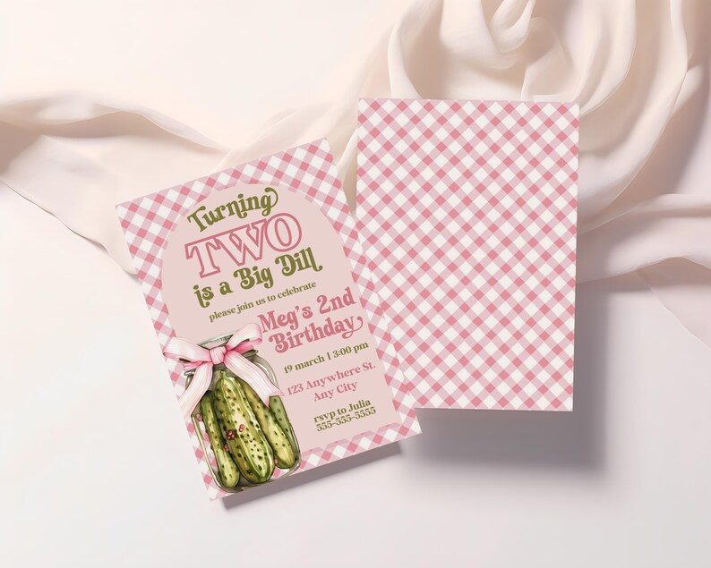 May include: Pink and white gingham birthday invitation with the text "Turning TWO is a Big Dill." The invitation features a pickle jar illustration and a pink bow. The second card has a pink and white gingham pattern.