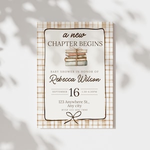 May include: A baby shower invitation with a plaid background and a cream-colored frame. The text "a new CHAPTER BEGINS" is at the top, with the name "Rebecca Wilson" and event details below. A stack of books is in the center.
