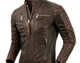 May include: A brown leather jacket with a distressed finish. The jacket features a stand-up collar, multiple zippered pockets, and quilted shoulder detailing. The jacket has a front zipper closure and a brown leather pull tab.