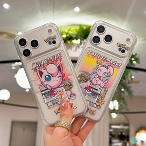 May include: Two clear phone cases featuring Pokemon characters. One case displays Jigglypuff with the text "Jigglypuff" and the other case shows Mew with the text "Dream". Both cases have the Pokemon Go logo and colorful graphics.