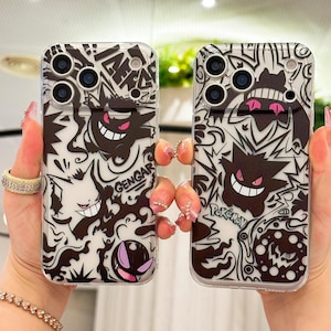 May include: Two clear phone cases with a black and white Gengar design. The cases feature a repeating pattern of Gengar, other Pokemon characters, and the word "Gengar". The cases have a clear background and are designed to fit a smartphone.