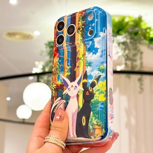 May include: A phone case with a colourful illustration of two cartoon characters, one white and one black, set against a building and a blue sky. The case has a glossy finish and a protective design.