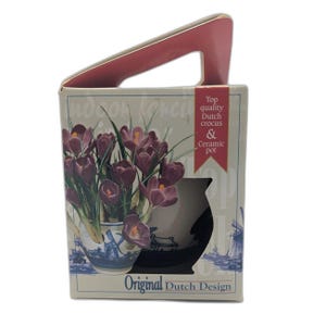May include: A decorative box with a handle, containing a ceramic pot of purple crocus flowers. The box is labelled "Top quality Dutch crocus & Ceramic pot" and "Original Dutch Design". The pot has a blue and white windmill design.