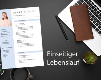 May include: A resume with the name "Julia Stein" and the title "Berufserfahrung" is displayed on a black surface, alongside a laptop, pen, notebook, and small plants. The text "Einseitiger Lebenslauf" is also visible.