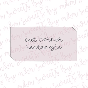 May include: A light pink cut corner rectangle cookie cutter with the words "cut corner rectangle" in cursive script. The background is a light pink and white pattern.