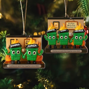May include: Green and yellow Christmas ornaments featuring cartoon characters with flames on their heads. Each ornament has a name on it, and the text "Putting out work fires together since 2025".