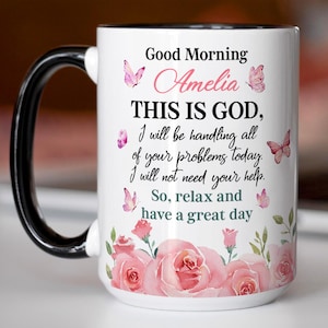 May include: White ceramic mug with a black handle and rim, featuring the text "Good Morning Amelia, THIS IS GOD, I will be handling all of your problems today. I will not need your help. So, relax and have a great day." Decorated with pink roses and butterflies.