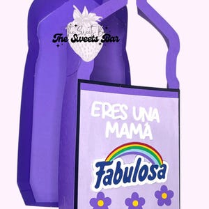 May include: A purple decorative container shaped like a cleaning product bottle. The front features the text "ERES UNA MAMA FABULOSA" with a rainbow and flower accents. The handle is yellow.
