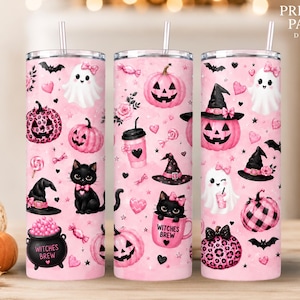 May include: Three cylindrical tumblers with lids and straws featuring a pink background with Halloween-themed illustrations including black cats, ghosts with pink bows, pink pumpkins, witch hats, and cauldrons labeled Witches Brew.