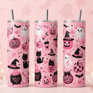 May include: Three tall cylindrical tumblers with silver straws, featuring a light pink background covered in a repeating pattern of black cats, white ghosts, pink pumpkins, witch hats, and cauldrons labeled Witches Brew in black text.