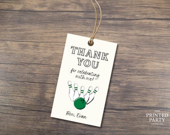 May include: A cream-colored tag with the words "THANK YOU" in bold black letters. Below, it reads "for celebrating with me!" with a bowling pin and ball graphic. The tag is tied with twine and includes the text "From, Evan."