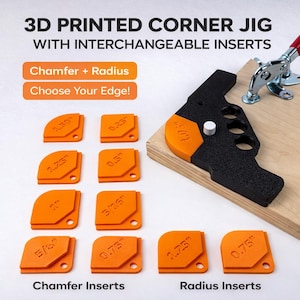 May include: A 3D printed corner jig with interchangeable inserts. The jig is black and orange, with a variety of orange chamfer and radius inserts. The inserts are labeled with measurements in inches, including 1.30", 1.25", 1", 5/8", 0.23", 0.5", 5/16", and 0.75".