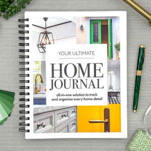 May include: A spiral-bound home journal with the title "YOUR ULTIMATE HOME JOURNAL." The cover features interior design images, including a green door, a gold faucet, and a yellow door. A green and gold pen rests on the right.