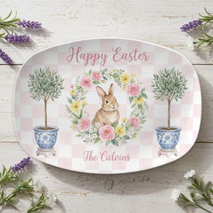 May include: A white ceramic mug with a black handle and the text "But First, Coffee" in a bold, black font. The mug is set against a blurred background, suggesting a cozy setting.