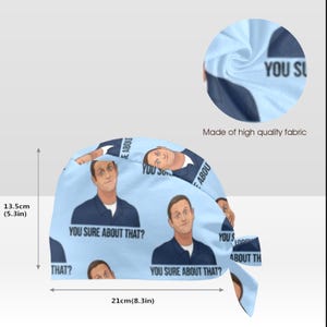 May include: A light blue scrub cap featuring a repeating illustration of a man in a dark blue polo shirt with the text "YOU SURE ABOUT THAT?" printed below. The cap measures 13.5 cm or 5.3 inches in height and 21 cm or 8.3 inches in width.