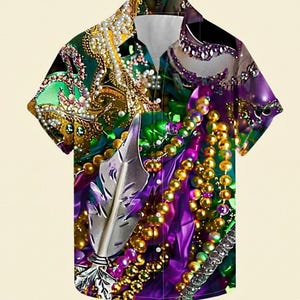 May include: Short-sleeved button-down shirt with a vibrant, detailed print. The design features a collage of Mardi Gras beads in gold, purple, and green, with a silver feather accent. The shirt has a classic collar and button closure.