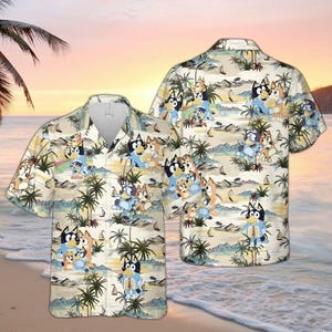 May include: Two short-sleeved button-down shirts with a tropical print featuring cartoon characters on a beach scene. The shirts have a beige background with palm trees, sailboats, and a sunset.