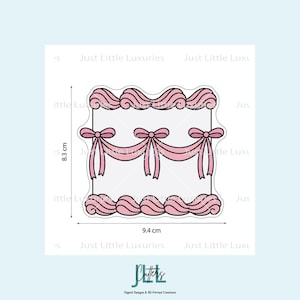 May include: A pink and white cake-shaped cookie cutter. The cutter is rectangular, with pink frosting details along the top and bottom edges. Pink bows are featured in the center. The cutter measures 8.3 cm high and 9.4 cm wide.