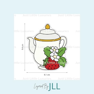 May include: A white teapot with gold trim, a red strawberry, green leaves, and white flowers. The teapot is 9.4 cm tall and 8.1 cm wide. The text "Layered By JLL" is at the bottom.