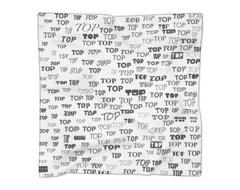 May include: White square scarf with the word "TOP" repeated in various fonts and sizes. The word is printed in black. The scarf is made of a soft, flowing fabric.