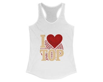 May include: White racerback tank top with the text "I ❤️ TOP" in a gold font, with a red heart and red and white striped design. The tank top has a scoop neck and a racerback design.
