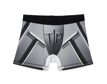 May include: Boxer briefs with a metallic silver design and a black waistband. The briefs feature the letters "T" and "P" in a stylized font on the front. The overall design has a futuristic, industrial aesthetic.