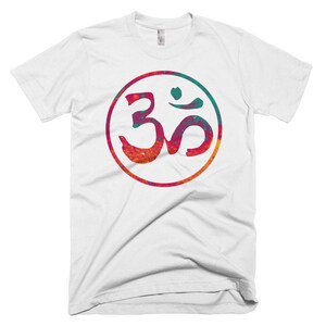 May include: White t-shirt with a colorful Om symbol in a circle. The symbol is a blend of red, orange, yellow, green, and blue.