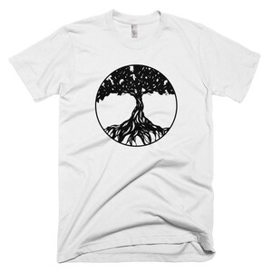 May include: White t-shirt with a black tree of life design in a circle.